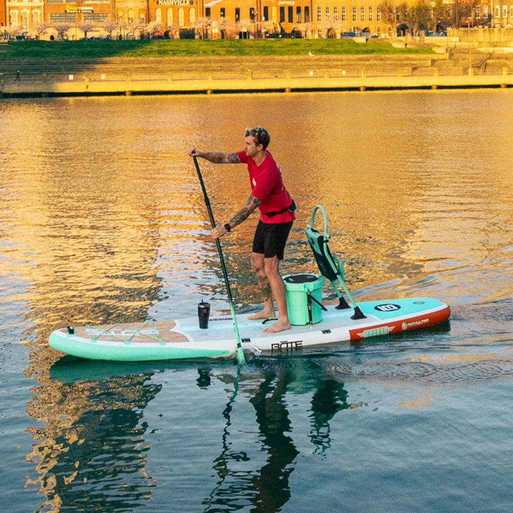 A guy paddling on a BOTE Breeze Aero Inflatable Paddle Board